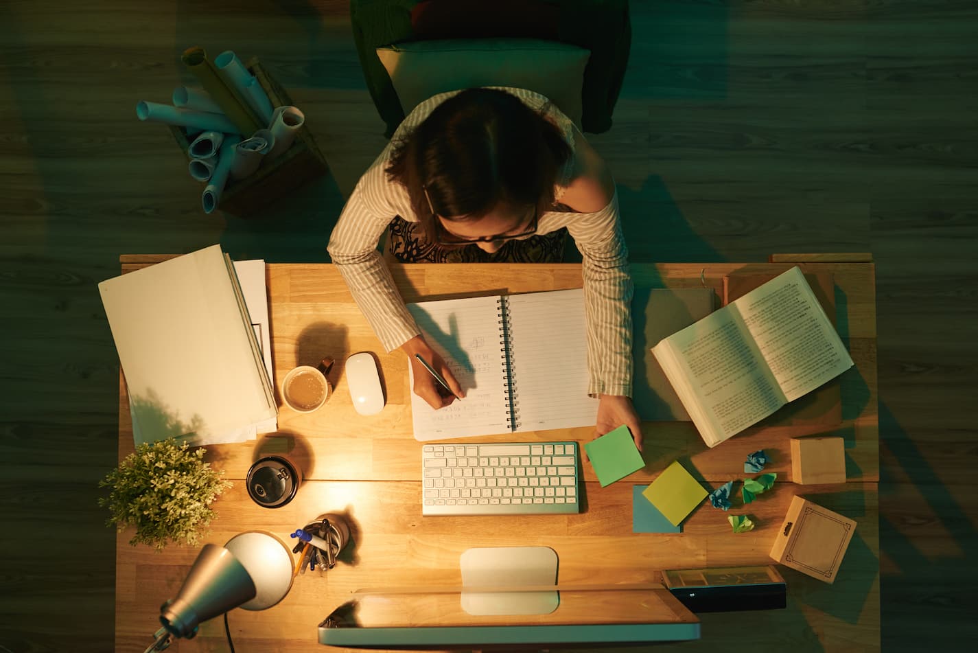 An image of a woman studying late at night