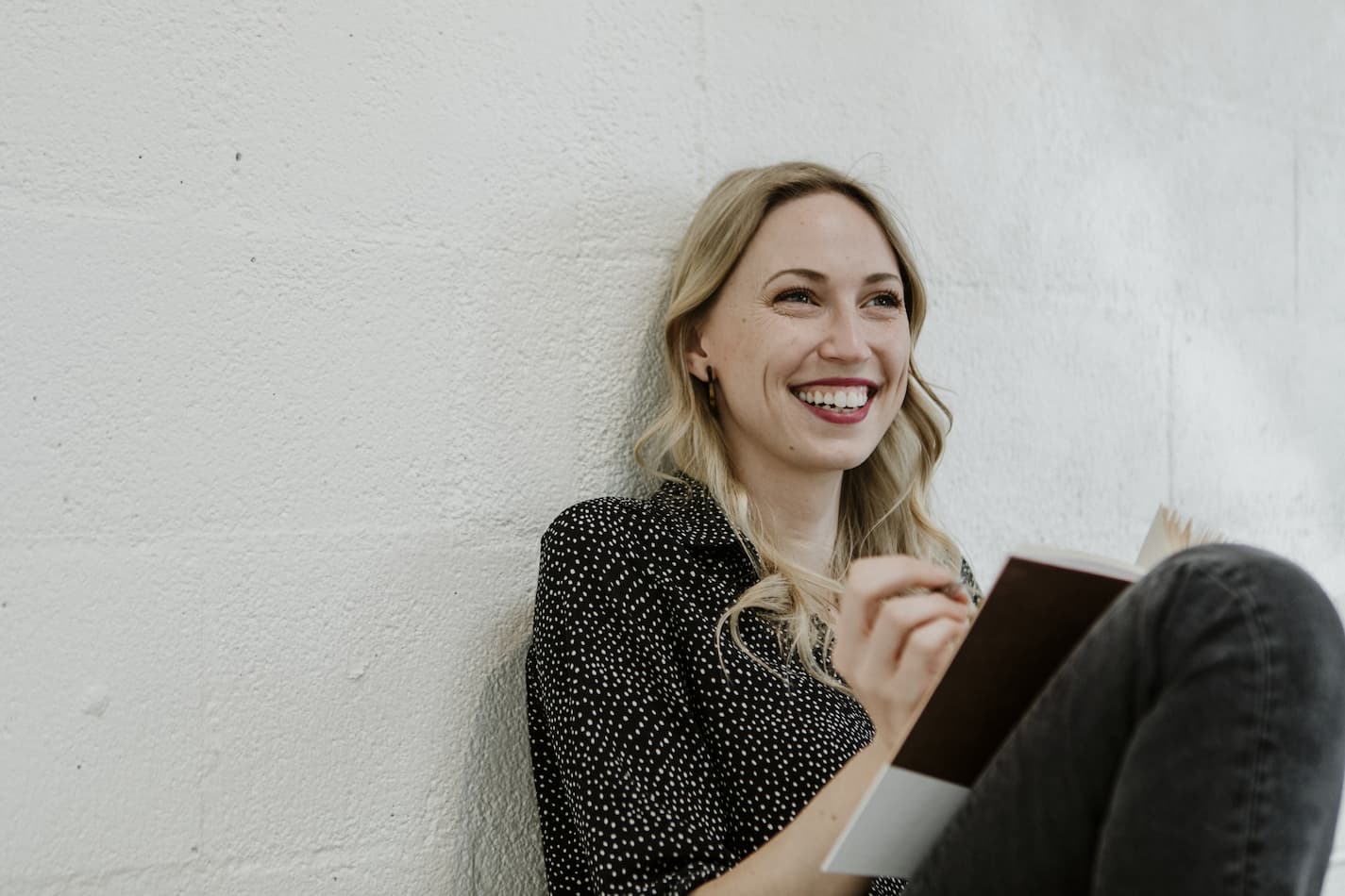 image of smiling woman writing notes