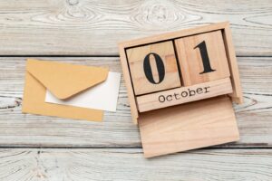 Image of blocks saying October 01 on a wooden background