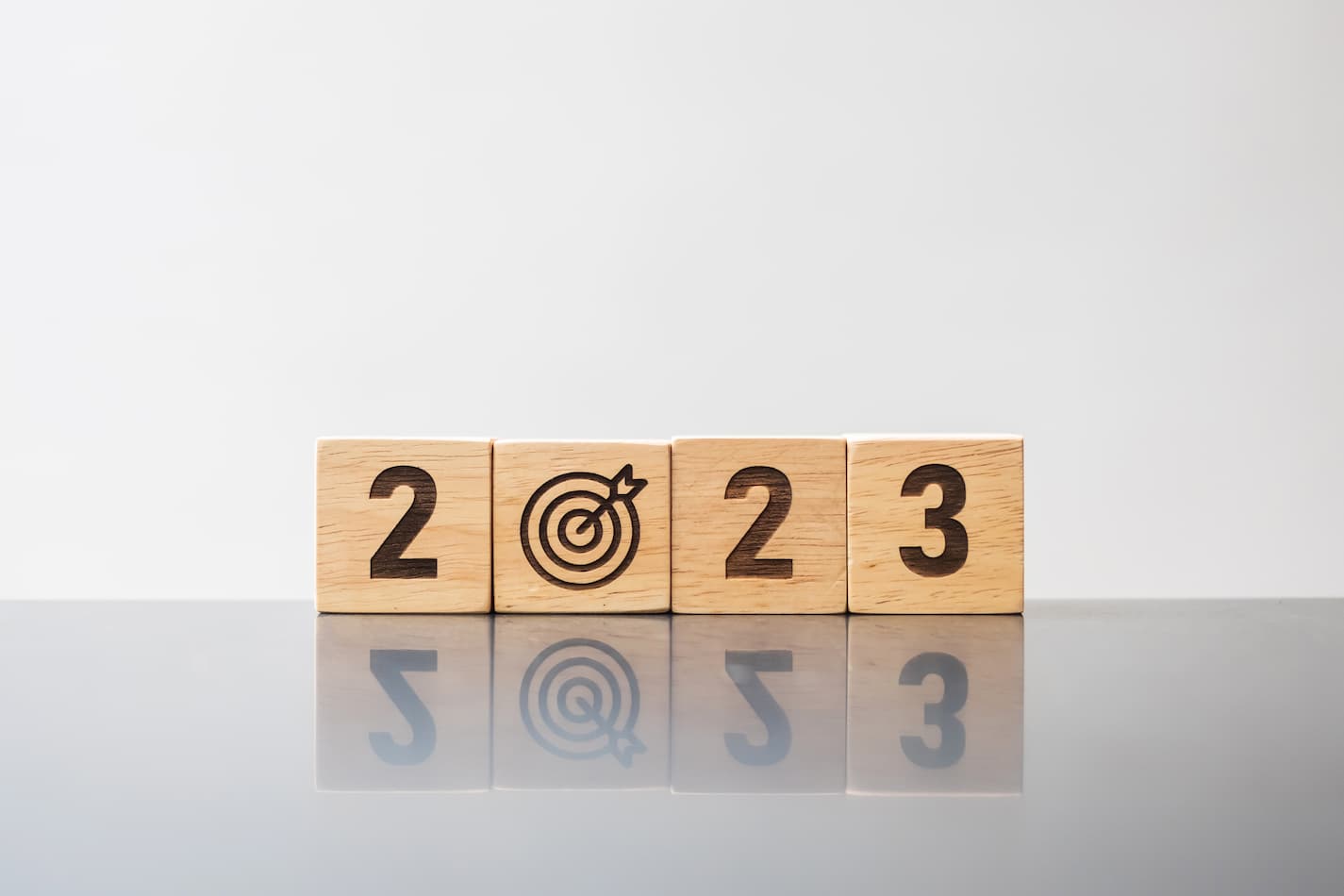 An image of blocks saying 2023, with the 0 having an arrow in a bullseye.